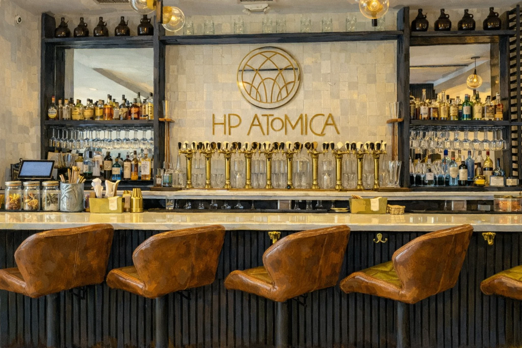 Hop Atomica bar in Louisville, Kentucky with gold tap handles, backlit bottles, and leather bar stools.