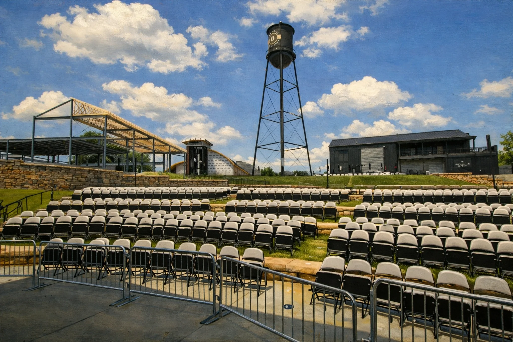 Outdoor amphitheater seating at Log Still Distillery in Kentucky with rows of chairs and a tall water tower in the background.