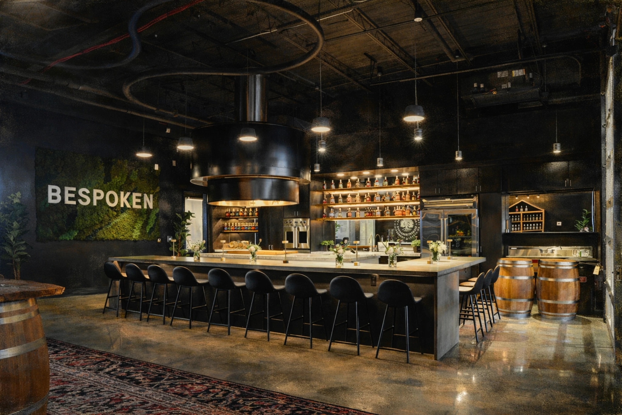 Interior view of the tasting bar at Bespoken Spirits with seating, overhead lighting, and spirit displays.
