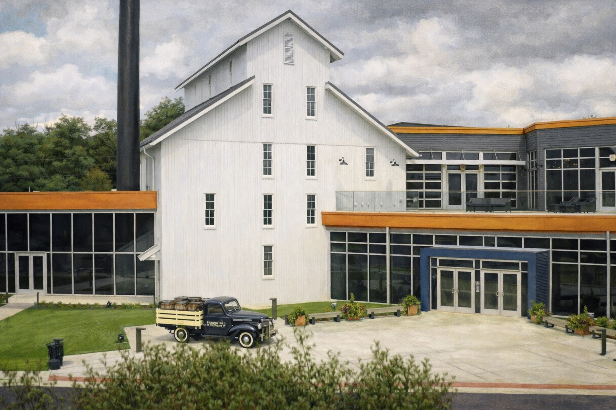 Wide exterior view of the Heaven Hill Bourbon Experience campus showing the visitor center entrance, landscaped courtyard, and historic distillery buildings.