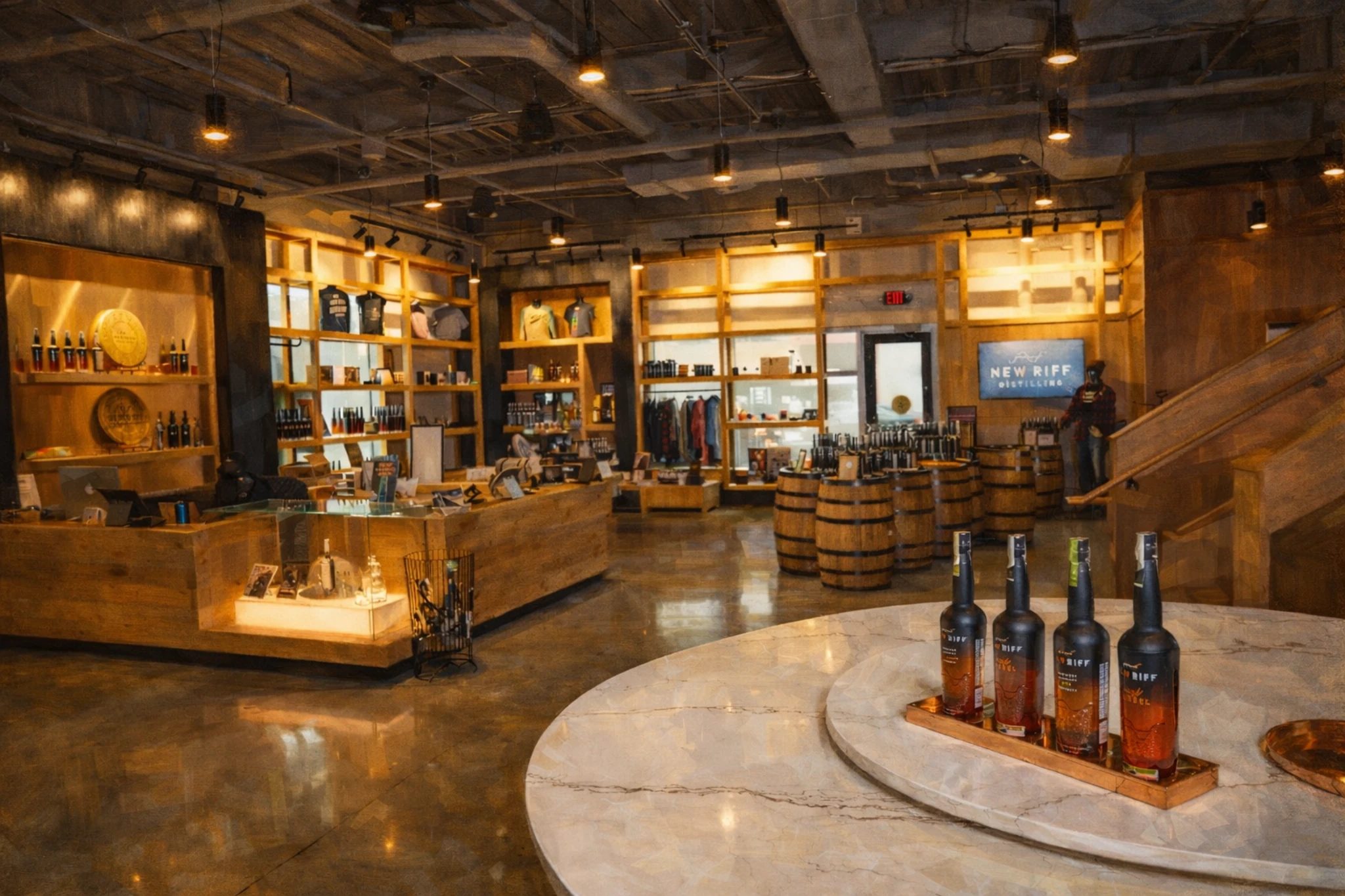 New Riff Distilling gift shop and retail area with wooden shelves, branded merchandise, and bottle displays.