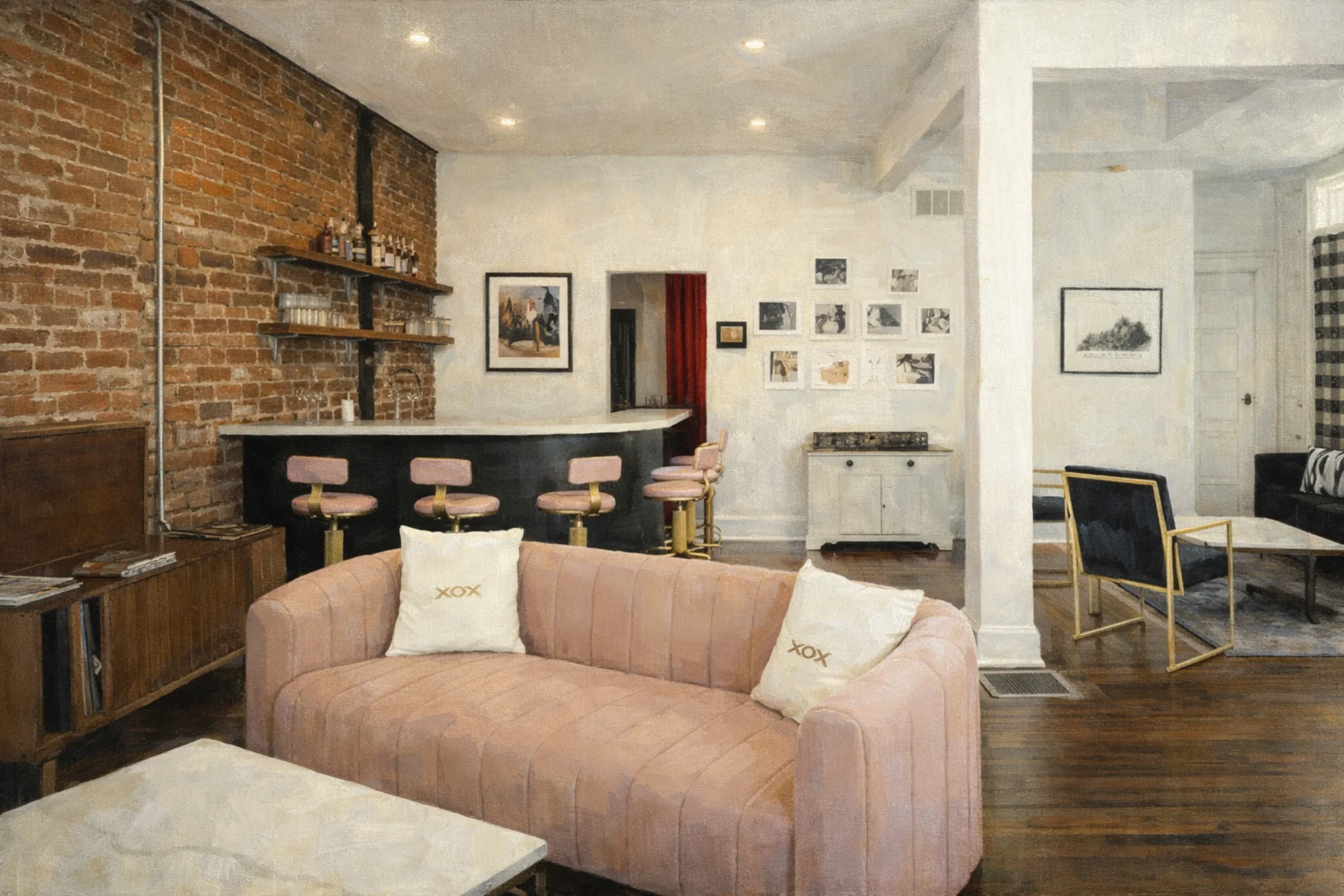 Interior lounge at Pensive Distilling Company with a pink sofa, brick wall, and small bar with pink stools.
