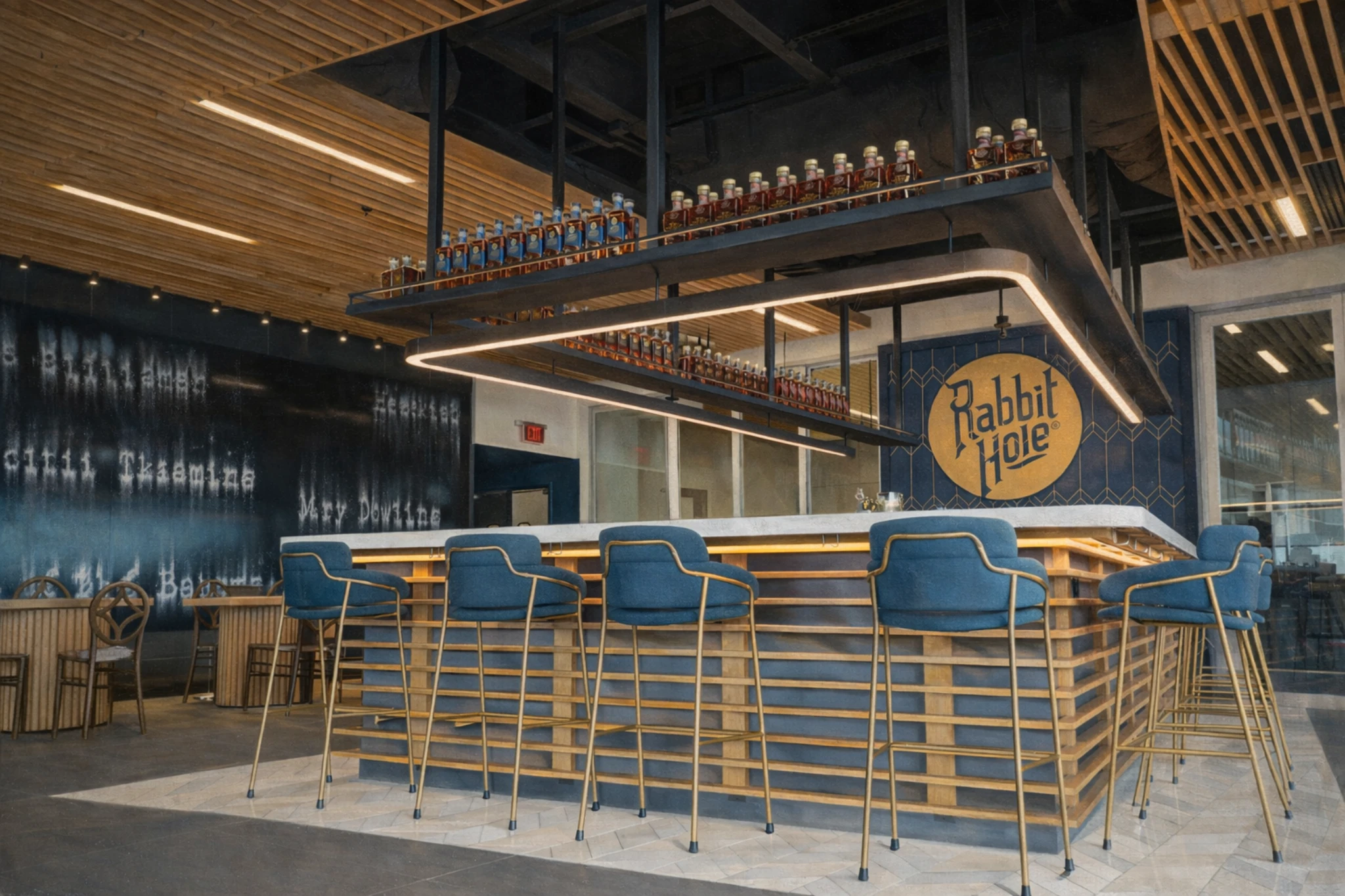 Interior bar area at Rabbit Hole Distillery featuring modern seating, bottle displays, and the Rabbit Hole logo on the wall.