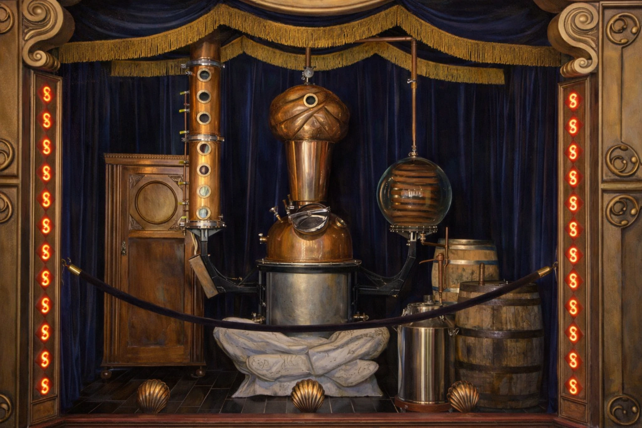 Copper pot still displayed on a stage inside Second Sight Spirits Distillery, framed by decorative curtains, lighting accents, and barrels.