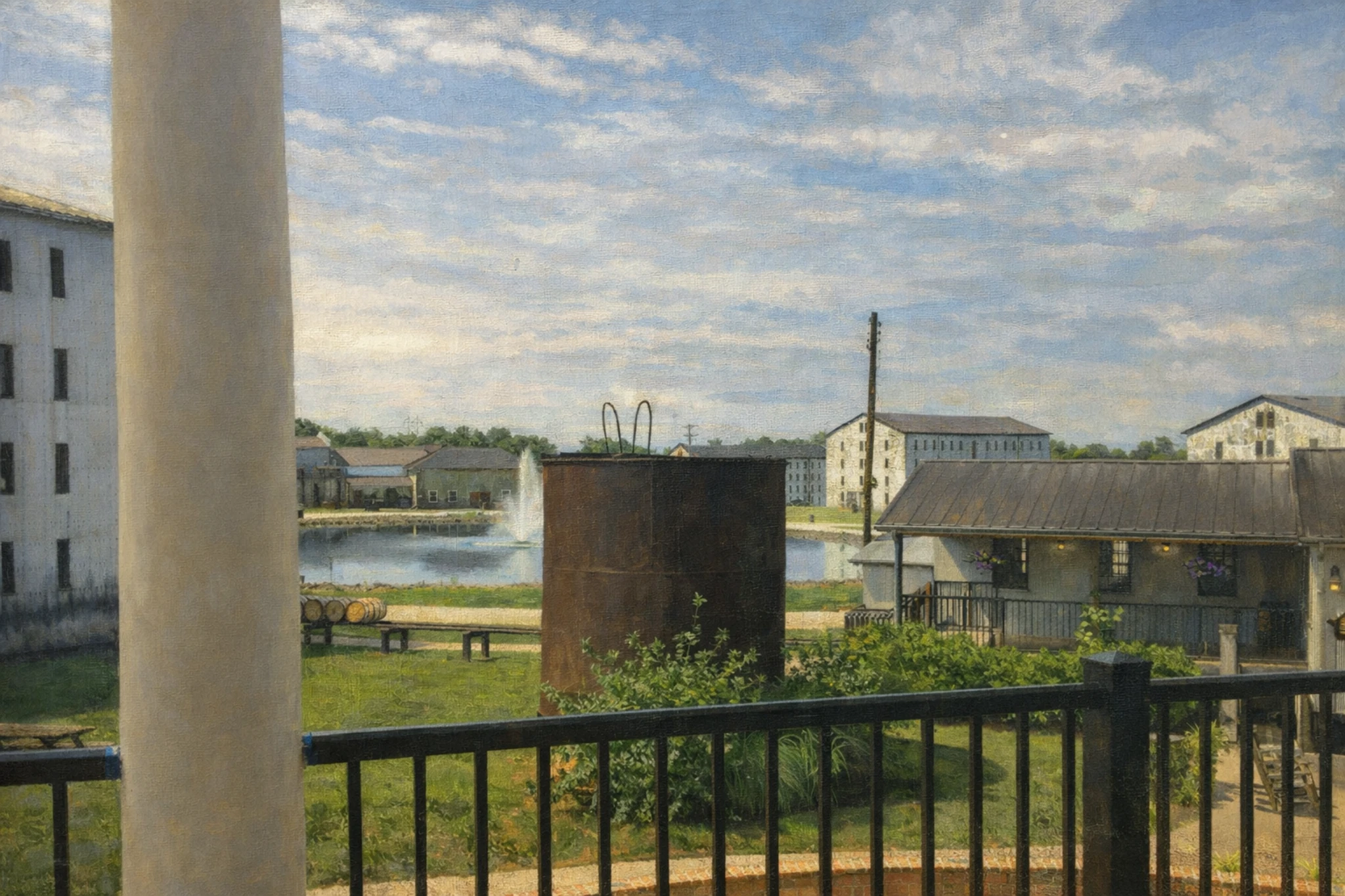 View from the Willett Distillery porch overlooking the distillery campus, pond with fountain, historic buildings, and landscaped grounds in Bardstown, Kentucky.