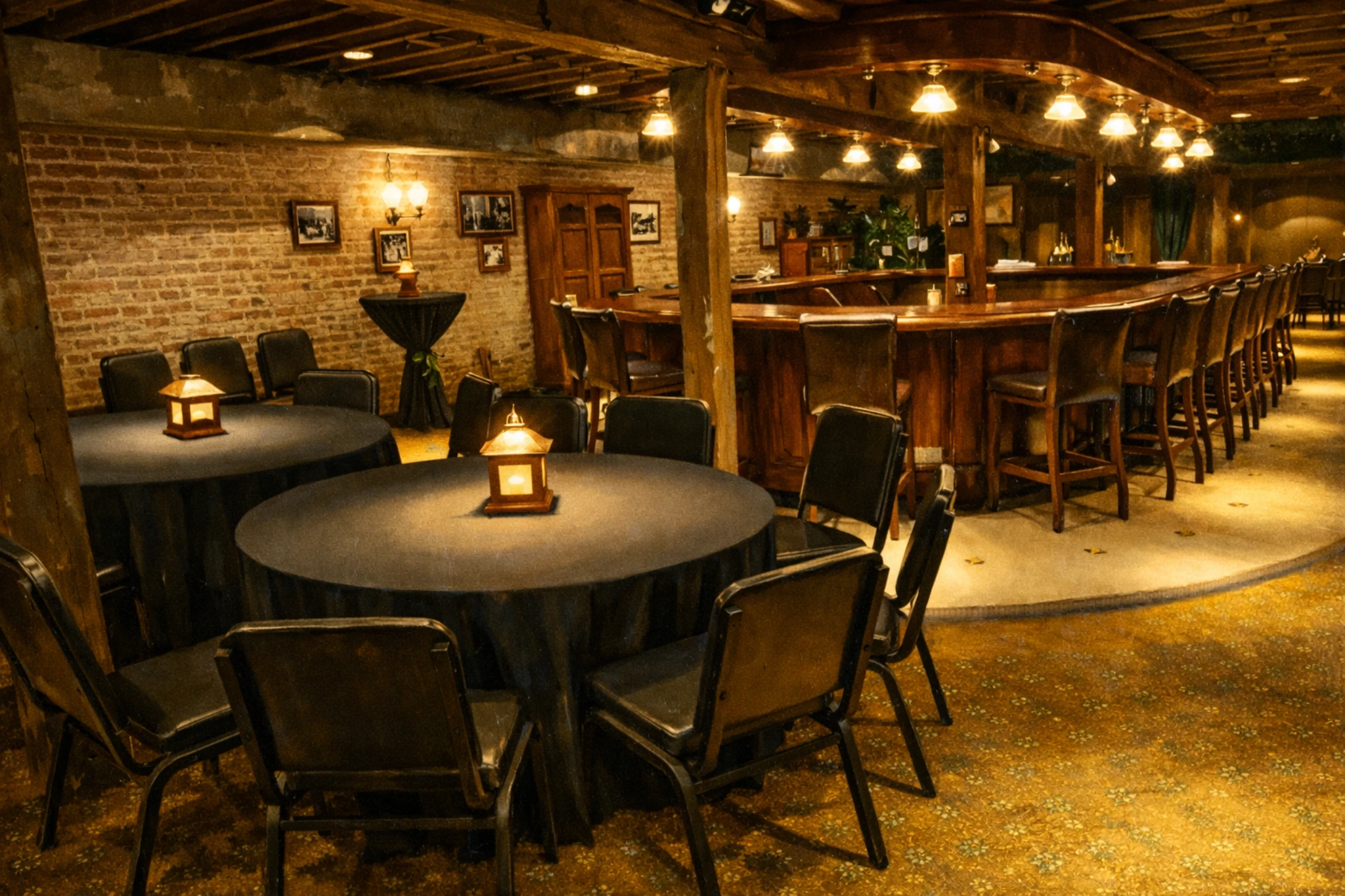 Rustic bar room at the Evan Williams Bourbon Experience with round tables, exposed brick, and warm lighting.